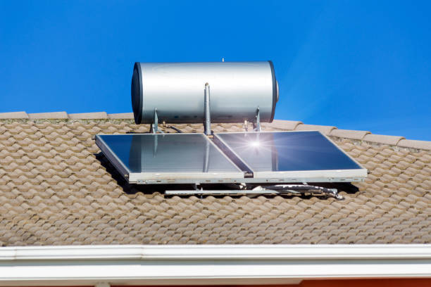 solar heater panels and sun beams  on the roof  alternative energy